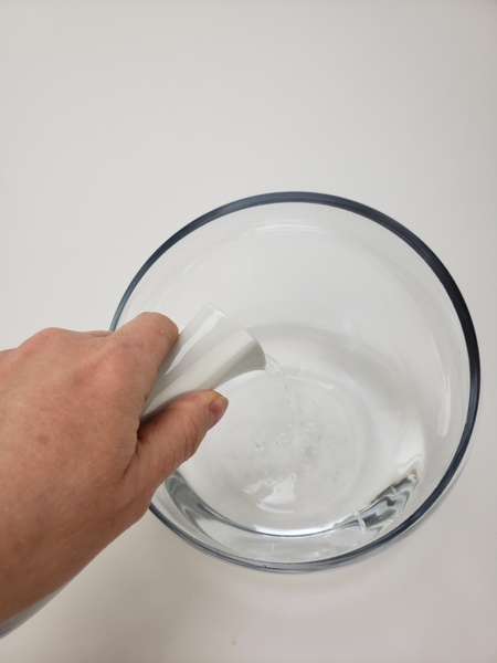 Pour water into a glass display container
