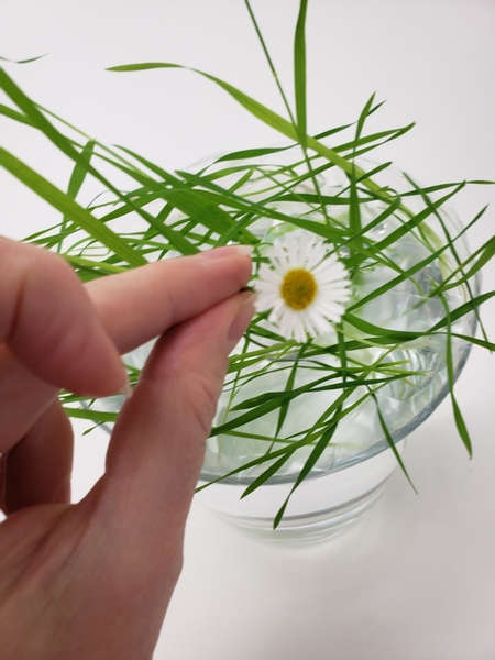 These tall grasses can carry some weight so place some of the flowers to gently rest on the blades of grass