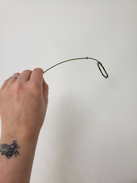 Adjust the handle by weaving in the cut end of the vine through the wreath