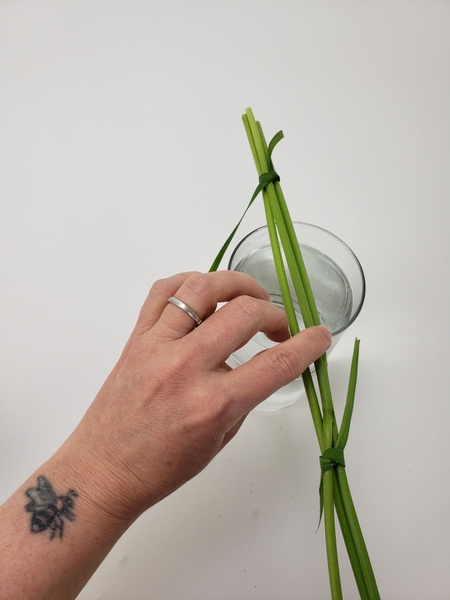 Wiggle the stems a bit so that they find a natural way to sit on the container