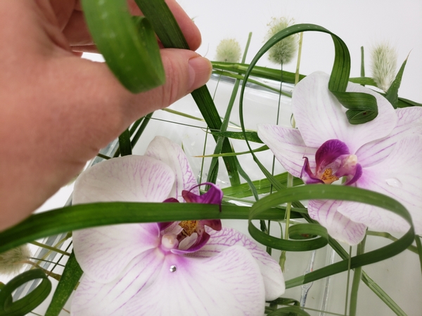 Add in a few curled grasses to dangle over the flowers