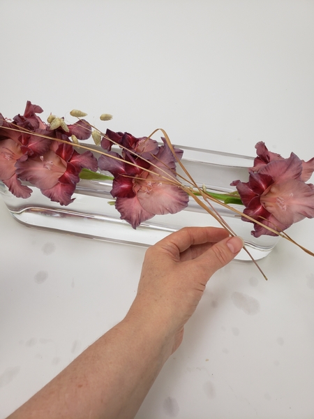 Drape dried Quaking Grass stems over the Gladiolus stems