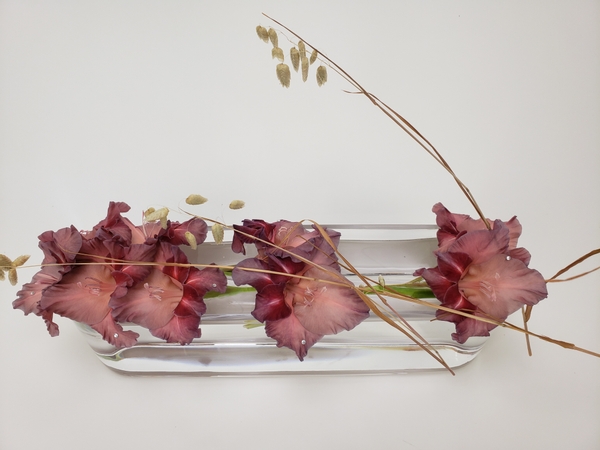 Earl grey gladiolus flowers in a sustainable floral design