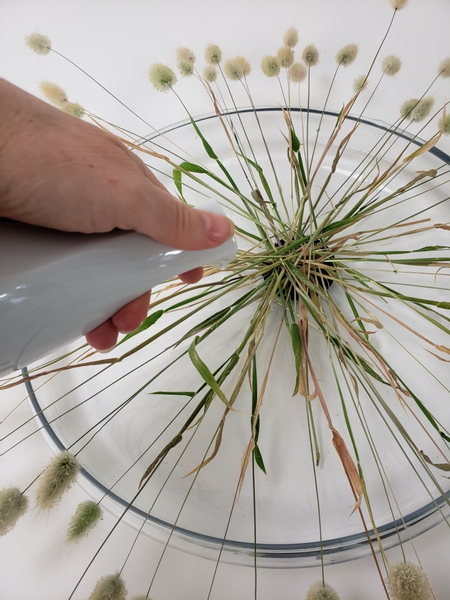 Fill the container with water to at least half way up the needles of the Kenzan