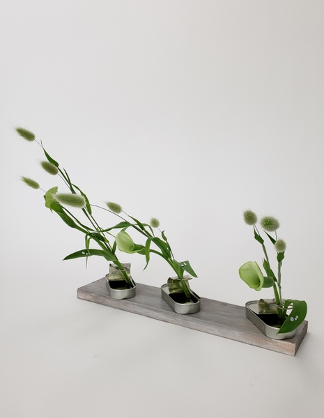Sustainable design idea using a can as a water source for a minimal floral arrangement