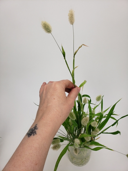 Insert the knotted grass into the container