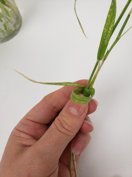 Wrap the grass around the two stems to latch them together
