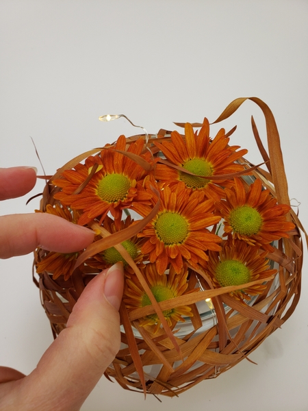 Allow the dried grasses to curl over the flowers