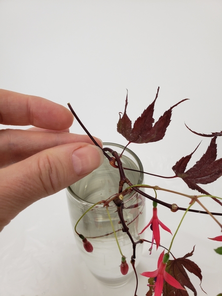 Hook a third pair of maple leaves through the curve to rest on the vase