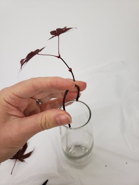 Slip the pliable stem into the opening of your bud vase