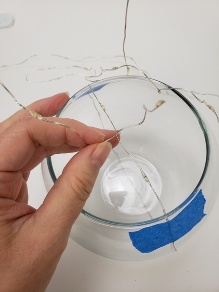 Twist the wire to secure in the middle of the opening of the vase