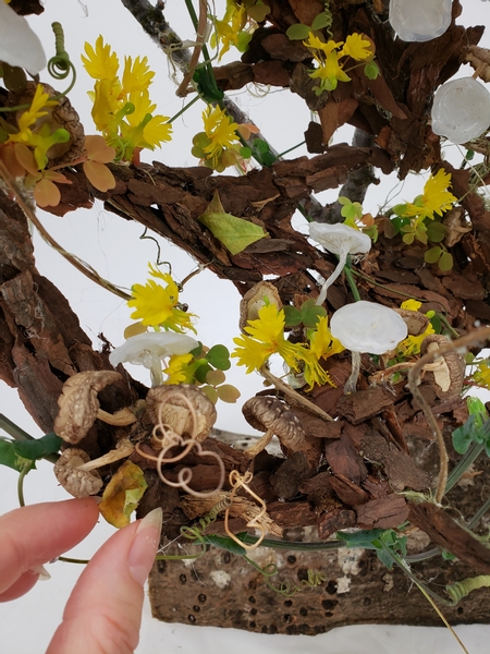 Use a tiny drop of floral glue to secure the leaves so that it looks like it floated down and gently settled in