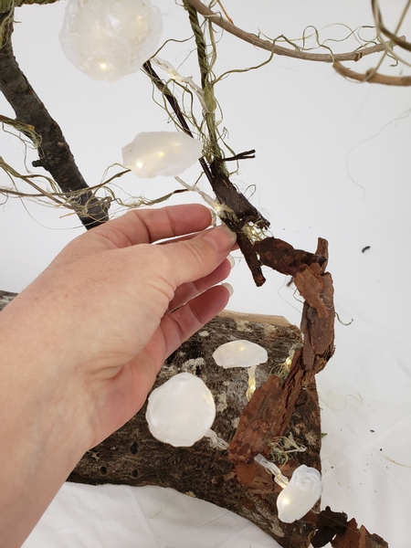 Use hot glue to glue the chips over the armature to create a bark covered forest floor for you to design on