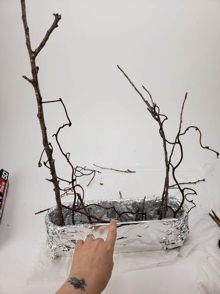 Add in the curly hazel twigs to curl around the upright stems