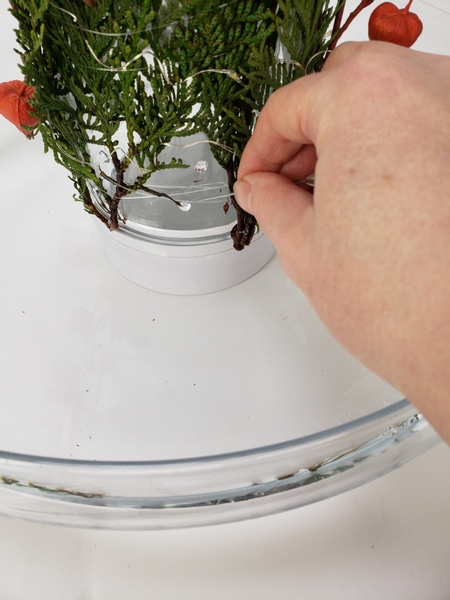 Add large dew drop crystals to sit on the glass in the gaps between the evergreens