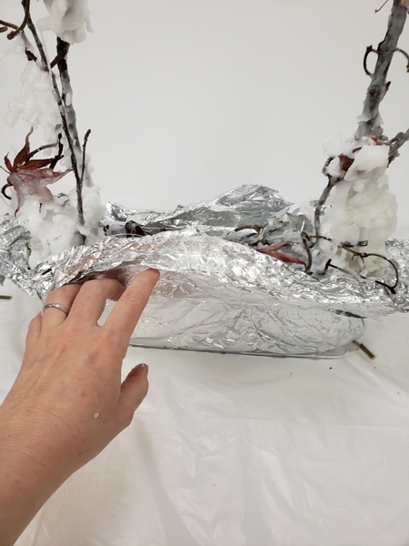 Cut away the line and fold the foil up over the wax to protect it from heat