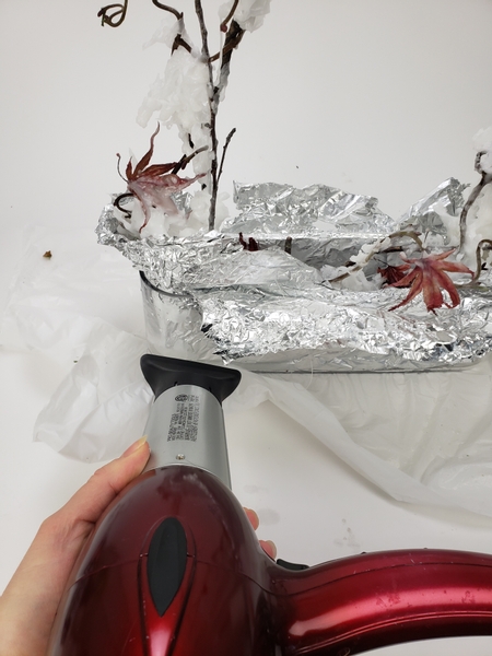 Heat the glass with a hairdryer to melt the wax