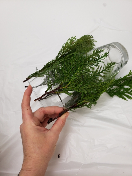 Move all the way around the vase and add greenery and binding it with the line