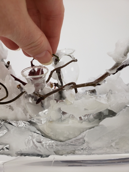 Slip a few sea horse water tubes in between the wax and twig pieces