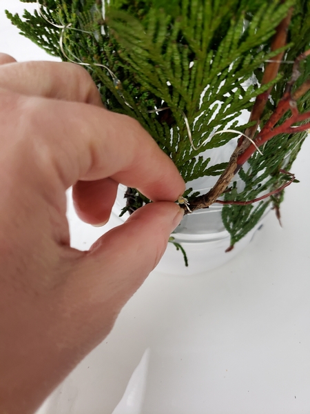 Twist the end of the solar light around a twig to secure it in place