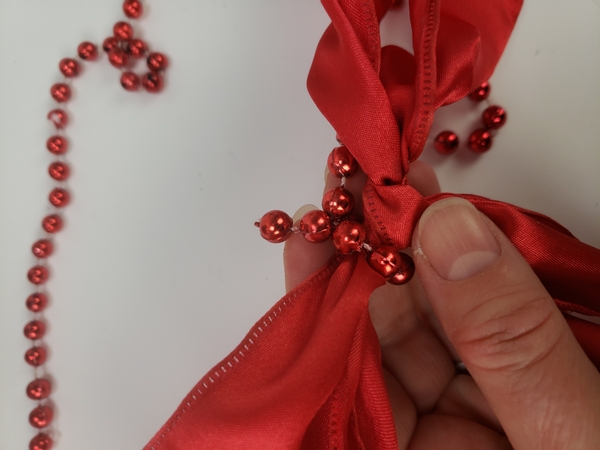 And as a final touch I twisted some of the beads around the bow in the red ribbon to bring it all together