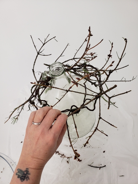 Break up the weaving shape with some wild twigs sticking over and around