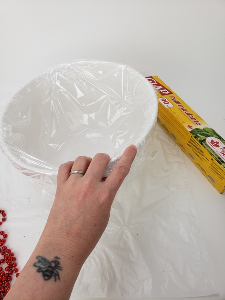 Cover a large bowl with plastic wrap