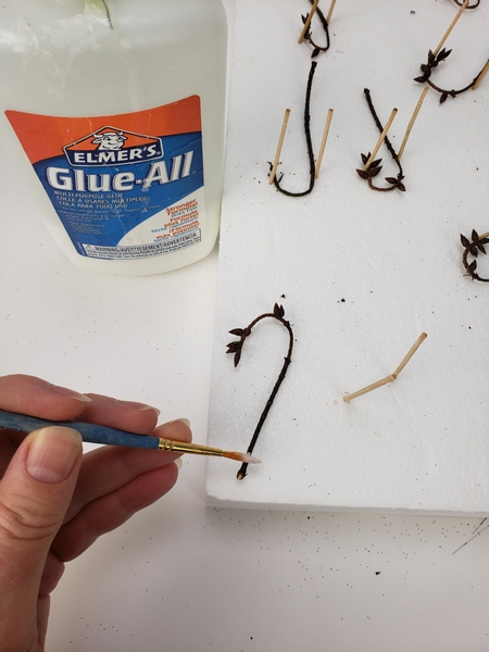 Place a drop of wood glue on the twig