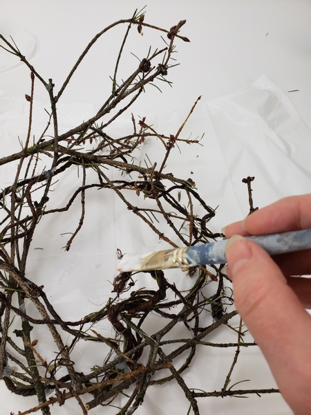 Place the twig wreath on a plastic lined design table