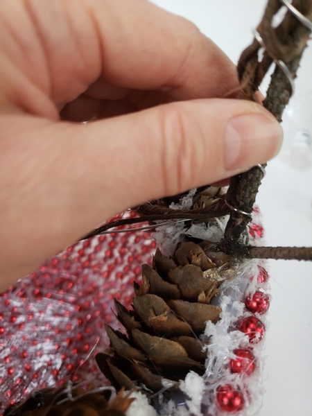 Press the wired stem between the pinecones and secure it with hot glue