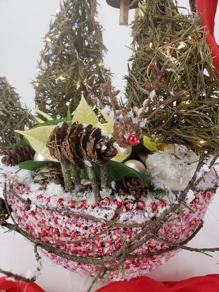 Rudolph the red nosed reindeer seed cone and twig hand crafted floral design for christmas