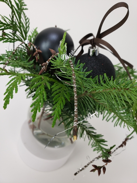 Shape a twig and add tinsel for natural Christmas decorations