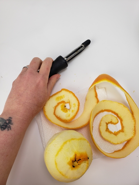 Spiral cut the peel from an orange with a vegetable peeler
