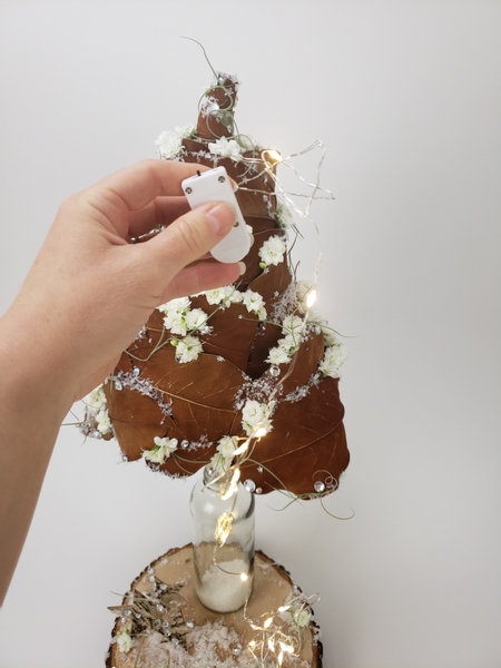 Tuck the on off switch of the star garlands into the leaf tree and dangle it down the sides