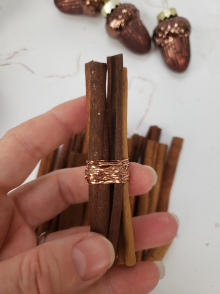 Wind the copper wire around a small bundle of cinnamon sticks
