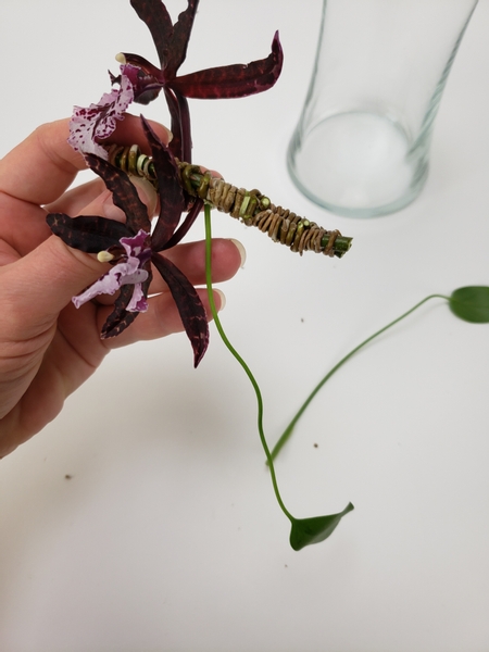 Add in the monstera leaves to fit into the weave in the same way as the orchids