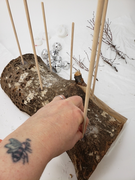 Cut a log in half so that you have a flat surface for it to stand on