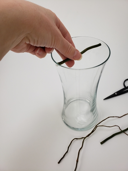 Measure a willow stem to rest just below the edge of the vase opening