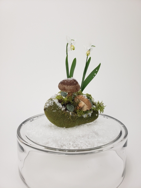 Moss and snow designs for a forest floor flower arrangement