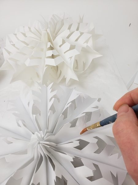 Paint the open snow flake with wood glue every here and there