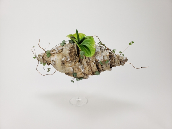 Spiral wrap some birch bark to display two anthurium flowers in a bud vase