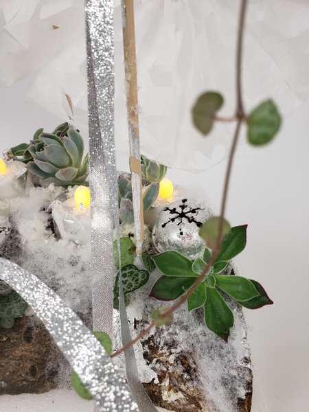 Yule log floral design with succulents and artificial snow
