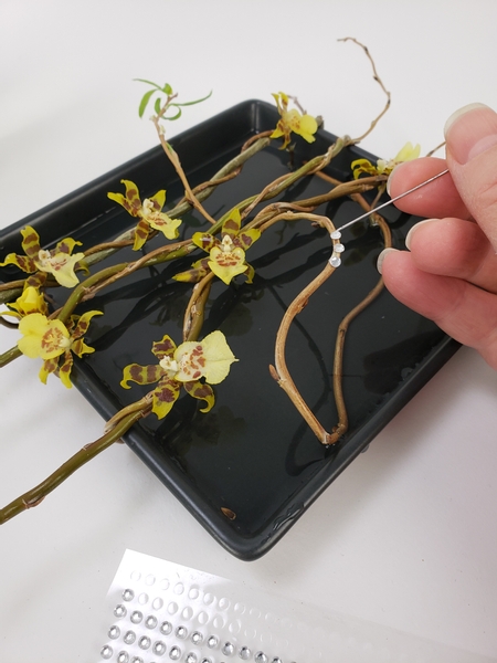 Add in a few dew drop crystals to gently rest on the willow twigs.