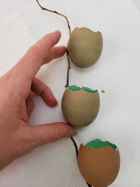 Adjust the egg shells so that it is in an almost straight line