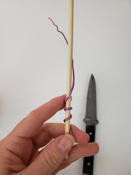 Twist wire around a bamboo skewer to curl it into tendrils
