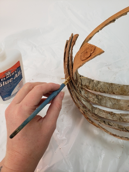 Use a brush to paint wood glue into all the layers to secure the strips into position