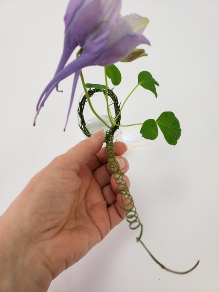 Slip the end of the vine coil through the wreath