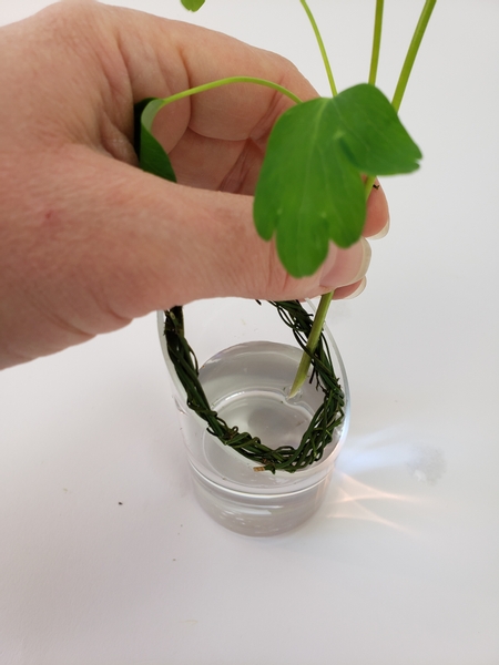 Wiggle the flower stem through the wreath