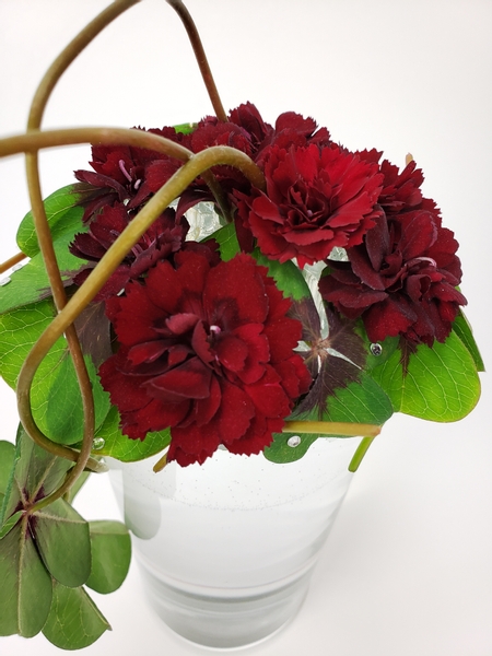Carnations displayed in a glass floral frog for a waste free display