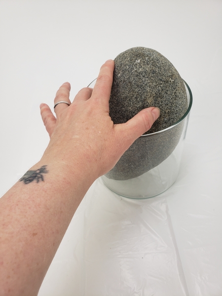 Lean a large pebble or rock in a glass display container